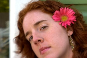 ###Rare Redhead: Brooke Cole, 26, Ocala### Redheaded Brooke Cole, 26, of Ocala, with Gerber Daisy in her hair from her garden, leans up against a home in the Ocala Historic District. Brooke required additional pain relievers while giving birth to her daughter Symon Cole, now age 4. There is research about redheads that finds them more senitive to pain, Thursday afternoon, April 14, 2005, Ocala, FL, USA. (Jannet Walsh/Star-Banner)2005
