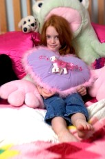 ###Rare Redhead: Riley Grace Mixson, 5, Ocala### Redheaded Riley Grace Mixon, 5, of Ocala, lounges in her bedroom with a few of her favorite pillows and stuffed animals. She is the daughter of Susan and Rick Mixson, Friday afternoon, April 15, 2005, Ocala, FL, USA. (Jannet Walsh/Star-Banner)2005