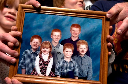 ###Rare Redhead: Family of eight redheads: Russell and Linda Rock, both redheads, and their six redheaded children, of the Florida Highlands### In the beginning there was just Linda Russell, 47, and her husband Russell Rock, 48, both redheads, that married 22 years ago. Russell's red hair has grayed and become darker, with a receding hairline. Today they have six children, all with red hair, with the ages of 8 to 21. Here the children hold a portrait of themselves from 2001. The family of redheads all live together, Monday evening, April 25, 2005, Florida Highlands, FL, USA. (Jannet Walsh/Star-Banner)2005