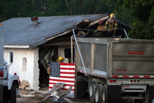 ###Truck goes through bar on South US Highway 301, Belleview###Marion County Fire-Rescue work to remove a semi truck from the north wall of Annie's Full Moon Saloon, located at 13214 South US Highway 301. The truck impacted the building about 5:15 am. The driver was reported to be dead, Tuesday morning, May 3, 2005, Belleview, FL, USA. (Jannet Walsh/Star-Banner)2005