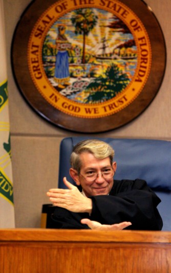 ###NEWS - FLAAS injunction hearing, Ocala- CONTACT PHOTOGRAPHER 352-598-7976 - cell### Judge Jack Singbush (cq) demonstrates with this hands is difficulties of deciding the injunction from case law presented in the injunction hearing of FLAAS has filed to keep the portable classrooms, Thursday evening, July 7, 2005, in Ocala, FL. (Jannet Walsh/Star-Banner)2005