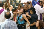 Ocala Star-Banner - Healing Conference, Ocala, FL.### Father Salomon Bravo of Bogota, Colombia, left, lays his hands on Nohemi Aguirre age 19, of Ocala, that falls backwards as she is receiving a healing. Becoming overwhelmed is called resting in the Holy Spirit, according to Father Alfonso Cely. Aguirre before the healing she was feeling depressed and was at peace and very calm. The event was hosted by the Hispanic Ministry of Blessed Trinity Catholic Church, for the First Grand Charismatic Healing Conference on Sept. 16 and 17, 2006. The theme of "Christ Heals in Spirit and Truth" for the many that gathered seeking healing. Speakers included Father Alfonso Cely of Blessed Trinity and Father Salomon Bravo of Bogota, Colombia. The "Redes" from Kissimmee and others provided music, Saturday morning, Sept. 16, 2006, Ocala, FL. ( Jannet Walsh/Star-Banner)2006