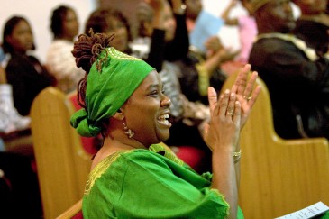 ###Ocala Star-Banner - 2006 Jubilee Celebration, Ocala FL - contact photographer at 352-598-7976### Tijuana Woods(cq) of Ocala, wearing African attire, claps after the song "Go Down Moses" is finished. The 2006 Jubilee Celebration service was held at the Zion United Methodist Church, Sunday evening, January 1, 2006, Ocala, FL. ( Jannet Walsh/Star-Banner)2006