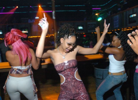 ##Graffiti Beach## Crystal Goadson, 21, of Ocala, center, dances to the hip hop music at Graffiti Beach as she holds on tighly to her identification card, Thursday evening, Feb. 17, 2005, Ocala, FL. (Jannet Walsh/Star-Banner)2005