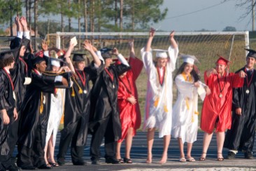 ###Ocala Star-Banner - Dunnellon High School graduation at Dunnellon High School Football Stadium, Dunnellon FL - Contact photographer at 352-598-7976. Photo Editor Alan Youngblood, 352-598-7967### Students do the wave as they wait for the start of the procession at the graduation at Dunnellon High School at Dunnellon High School Football Stadium, Friday evening, May 19, 2006, Dunellon, FL. ( Photo by Jannet Walsh/Star-Banner)2006