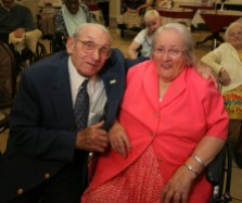 ####Pauline and Earl Raub celebrating 80th wedding anniversary at Avante Nursing and Rehab Center, Leesburg##Earl Raub, 96, and wife Pauline Raub, 95, both of Weirsdale, but Pauline currently is a resident of Avante Nursing and Rehab Center in Leesburg. Here the couple is all smiles after sharing a kiss at their 80th wedding anniversary with singing by Bob Rodgers, of Ocala. Their daughter Paulina Maxson, (cq) 77, of Weirsdale, was on hand for the celebration. The couple is possibly the oldest known current married couple in the United States, and possibly second to a couple in England. When asked how long they have been married, Pauline state, "It's been a long time gone." Sunday afternoon, June 5, 2005, Leesburg, FL, USA. (Jannet Walsh/Star-Banner)2005