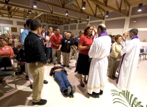 ###Ocala Star-Banner - Healing Conference, Ocala, FL.### Maria Diaz(cq) of Clermont, lays on the floor as she rests in the Holy Spirit after she received a healing. She doing a healing by proxy for a family member that is very ill. Becoming overwhelmed is called resting in the Holy Spirit, according to Father Alfonso Cely(cq). Aguirre(cq) before the healing she was feeling depressed and was at peace and very calm. The event was hosted by the Hispanic Ministry of Blessed Trinity Catholic Church, for the First Grand Charismatic Healing Conference on Sept. 16 and 17, 2006. The theme of "Christ Heals in Spirit and Truth" for the many that gathered seeking healing. Speakers included Father Alfonso Cely(cq) of Blessed Trinity and Father Salomon Bravo(cq) of Bogota, Colombia. The "Redes" from Kissimmee and others provided music, Saturday morning, Sept. 16, 2006, Ocala, FL. ( Jannet Walsh/Star-Banner)2006